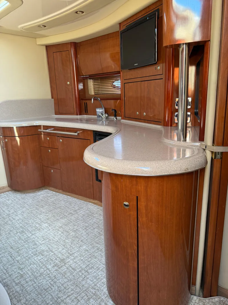 Slide: The Image of Luxurious interior of 2003 Sea Ray 420 Sundancer yacht with sleek wooden cabinetry. - 14