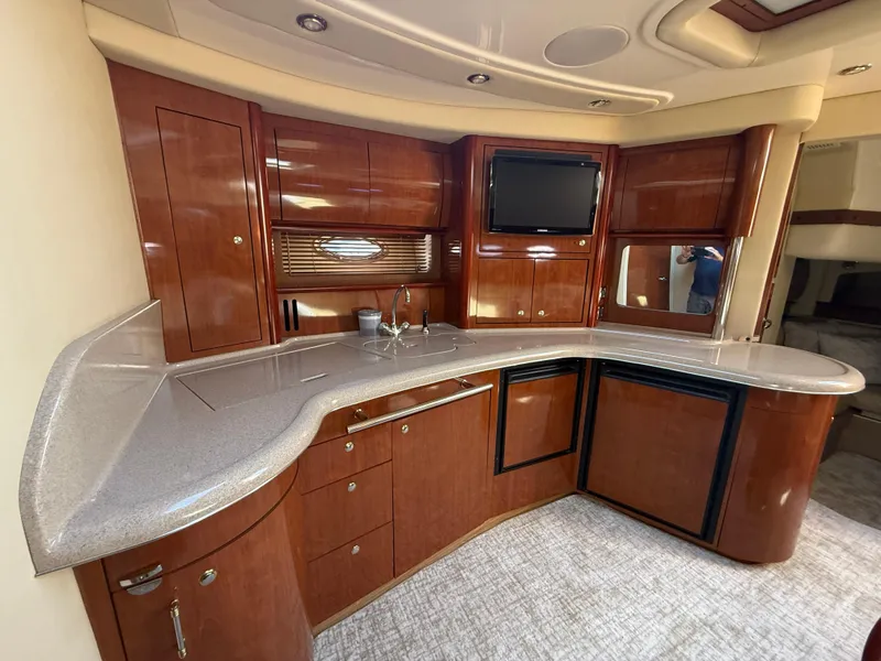 Slide: The Image of Luxurious 2003 Sea Ray 420 Sundancer yacht interior with elegant wood cabinetry and modern amenities. - 15