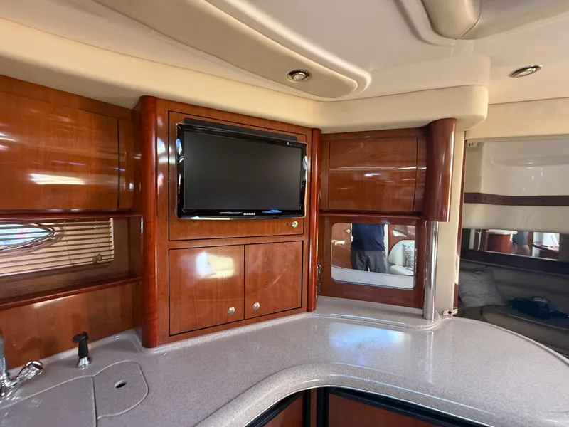 Slide: The Image of Luxurious interior of 2003 Sea Ray 420 Sundancer yacht with wood cabinetry and TV. - 16