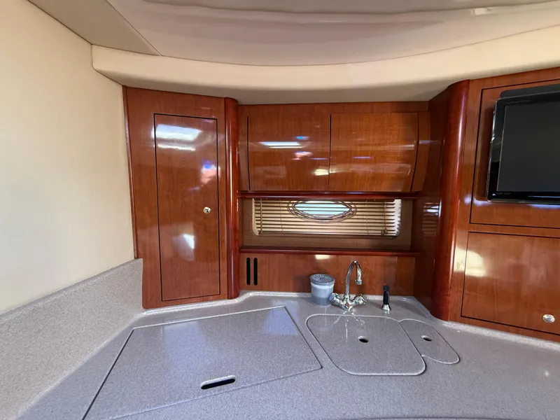 Slide: The Image of Luxurious interior of 2003 Sea Ray 420 Sundancer yacht with wood cabinetry and modern amenities. - 17