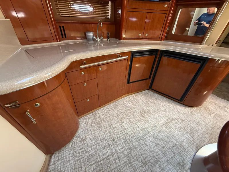 Slide: The Image of Luxurious kitchen area in a 2003 Sea Ray 420 Sundancer yacht with wood cabinetry. - 18