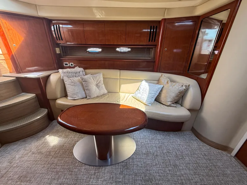 Slide: The Image of Luxurious interior of 2003 Sea Ray 420 Sundancer yacht with plush seating and elegant wood finishes. - 19