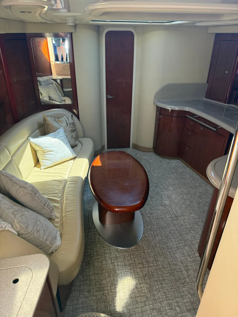 Slide: The Image of Interior of 2003 Sea Ray 420 Sundancer yacht with elegant seating and wooden table. - 25