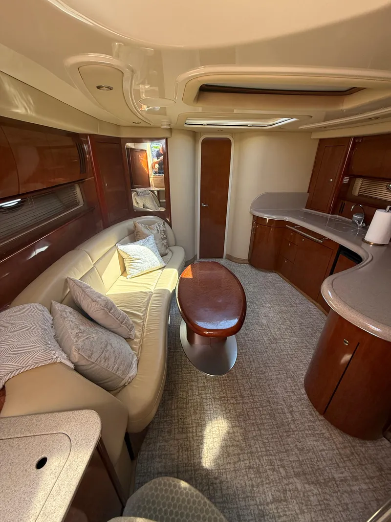 Slide: The Image of Luxurious interior of 2003 Sea Ray 420 Sundancer yacht with plush seating and elegant wood finishes. - 26