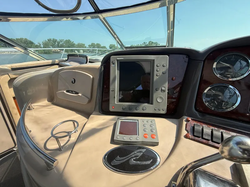 Slide: The Image of Dashboard of 2003 Sea Ray 420 Sundancer with navigation equipment and controls. - 28