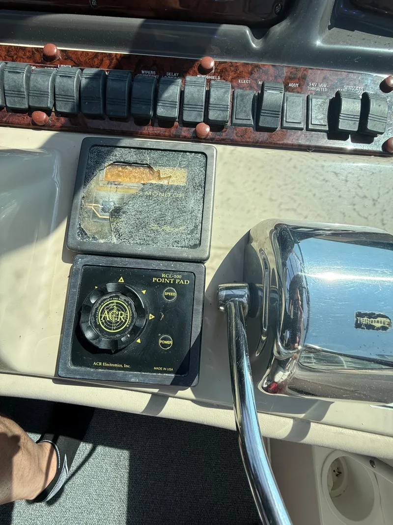 Slide: The Image of Control panel of a 2003 Sea Ray 420 Sundancer boat with switches and throttle. - 29