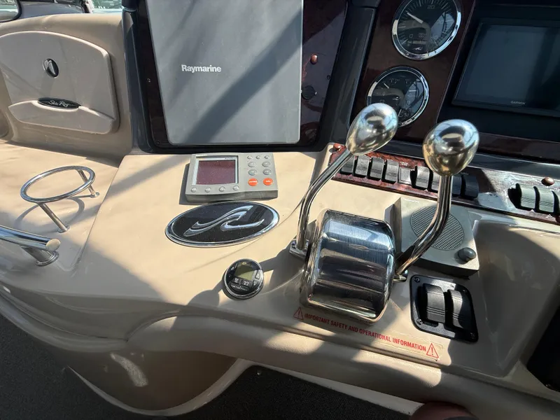Slide: The Image of Control panel of a 2003 Sea Ray 420 Sundancer with Raymarine equipment and throttle levers. - 30