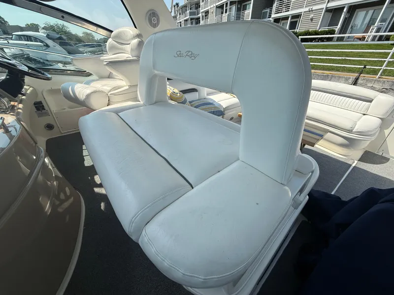 Slide: The Image of Interior seating of 2003 Sea Ray 420 Sundancer yacht, featuring white leather upholstery. - 32
