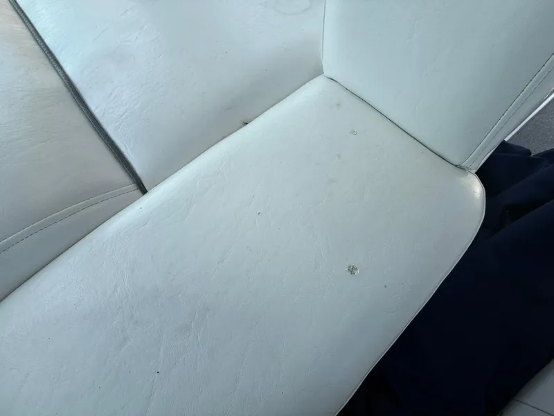 Slide: The Image of White leather seat on 2003 Sea Ray 420 Sundancer boat, showing minor wear. - 33