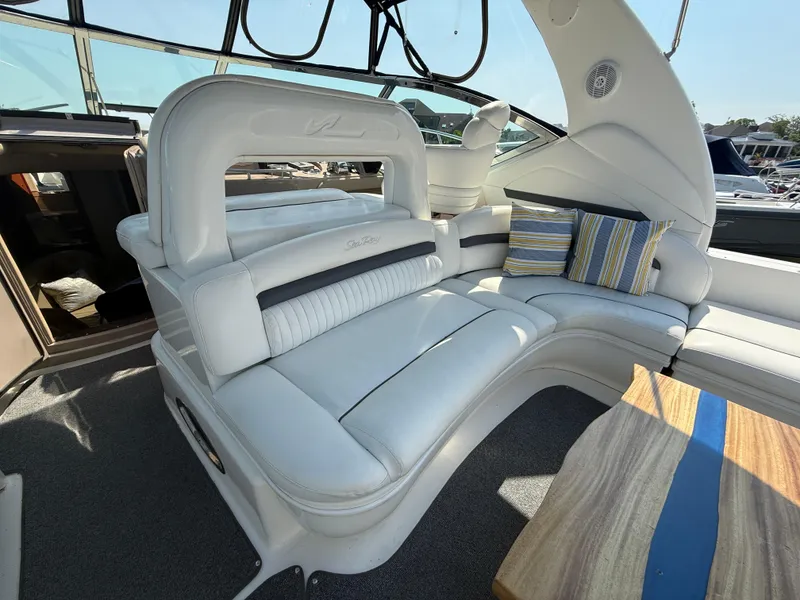 Slide: The Image of Luxurious interior of 2003 Sea Ray 420 Sundancer with plush seating and striped cushions. - 37