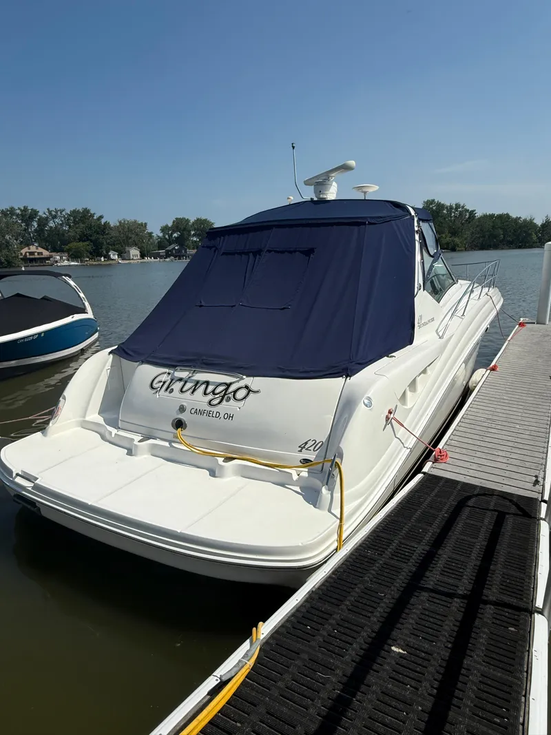 Slide: The Image of 2003 Sea Ray 420 Sundancer docked with blue cover, rear view. - 4