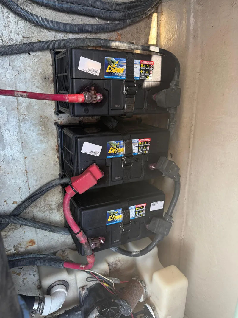 Slide: The Image of Battery setup in a 2003 Sea Ray 420 Sundancer boat engine compartment. - 41