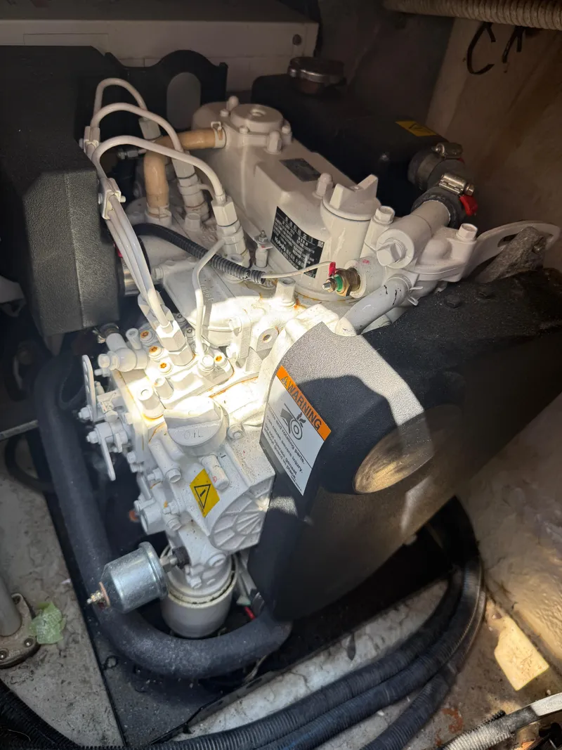 Slide: The Image of Engine compartment of a 2003 Sea Ray 420 Sundancer boat, showing mechanical components. - 42