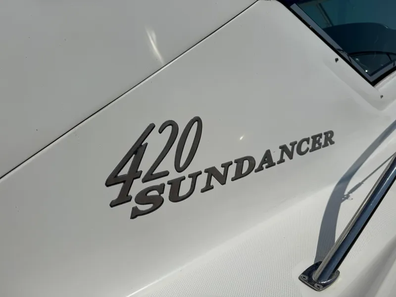 Slide: The Image of Close-up of 2003 Sea Ray 420 Sundancer boat nameplate on white hull. - 5