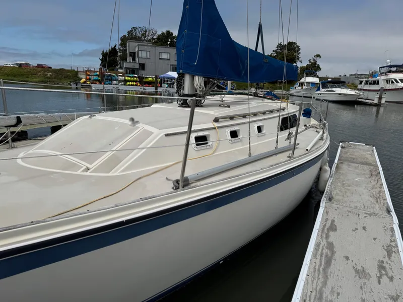 Slide: The Image of 1982 O'Day 34 sailboat docked at marina with blue sail cover. - 2