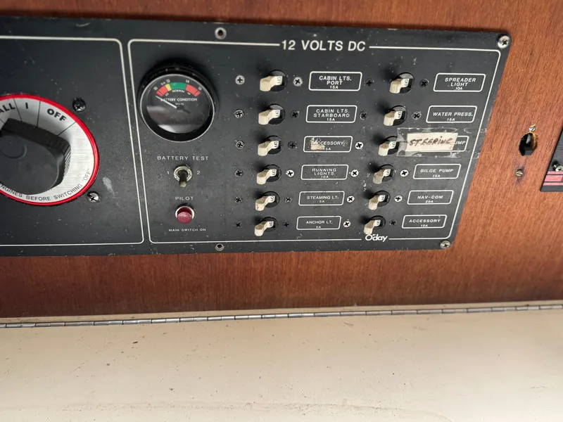 Slide: The Image of Control panel of a 1982 O'Day 34 sailboat, featuring 12 volts DC switches and battery test gauge. - 6