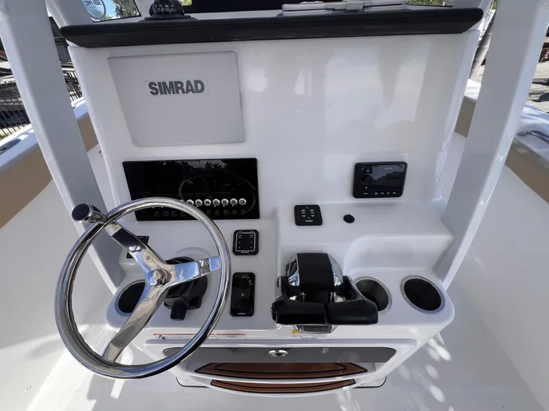 Slide: The Image of 2026 Sea Pro 262 Sport boat console with steering wheel and Simrad electronics. - 13