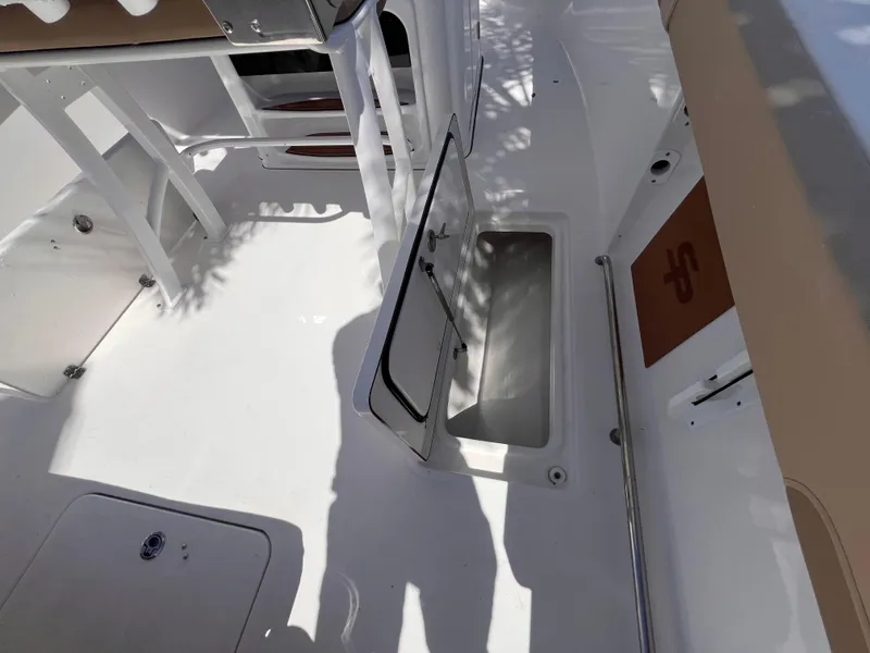 Slide: The Image of 2026 Sea Pro 262 Sport boat interior with open storage compartment. - 17