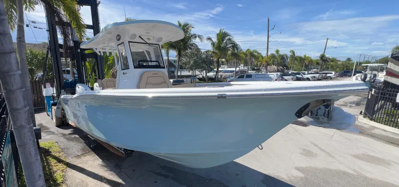 Slide: The Image of 2026 Sea Pro 262 Sport boat docked under clear blue sky. - 2