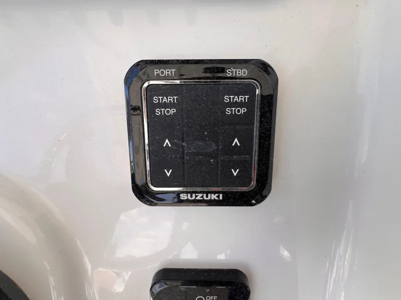 Slide: The Image of Control panel of a 2026 Sea Pro 262 Sport boat with Suzuki branding. - 20