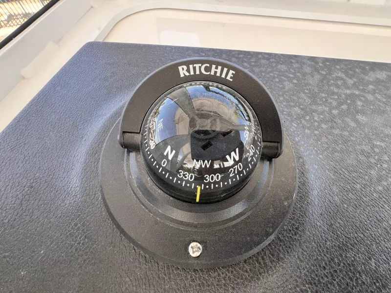 Slide: The Image of Ritchie compass on 2026 Sea Pro 262 Sport boat dashboard. - 25
