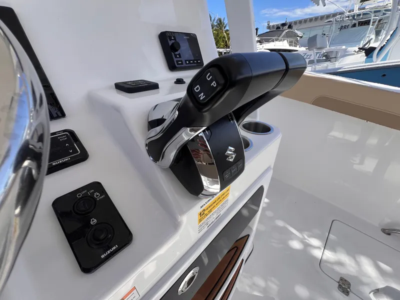 Slide: The Image of 2026 Sea Pro 262 Sport boat controls with Suzuki throttle and dashboard instruments. - 27