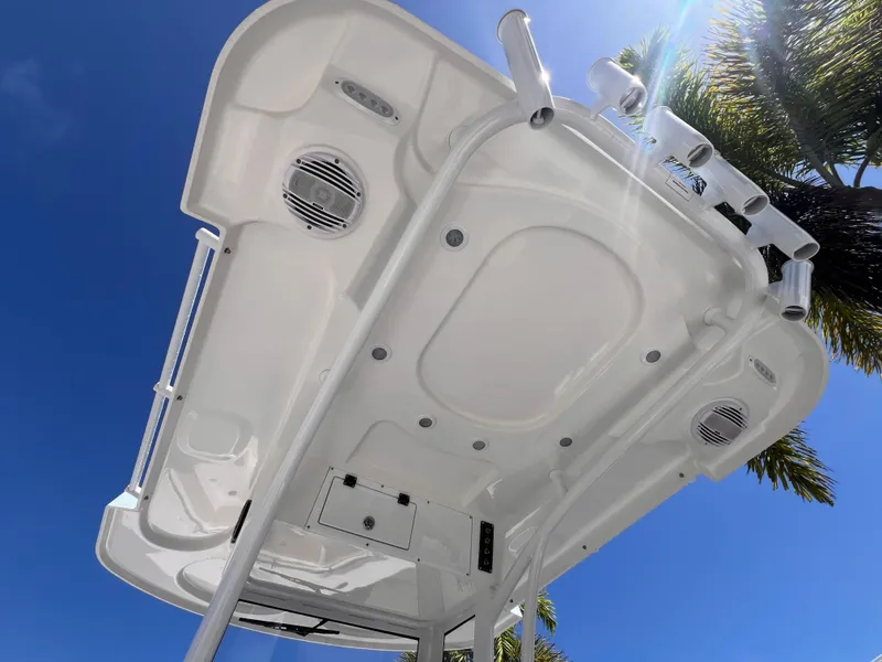 Slide: The Image of 2026 Sea Pro 262 Sport boat canopy with speakers, under a clear blue sky. - 30