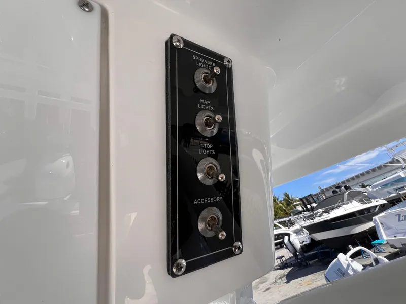 Slide: The Image of Control panel on 2026 Sea Pro 262 Sport boat with labeled switches for various lights. - 32