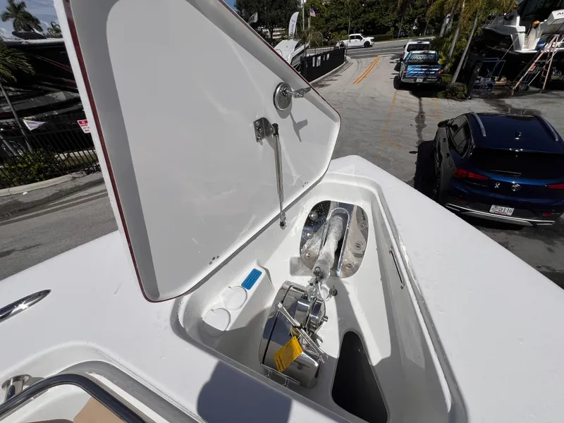 Slide: The Image of Open anchor compartment on 2026 Sea Pro 262 Sport boat, showing anchor and storage. - 33