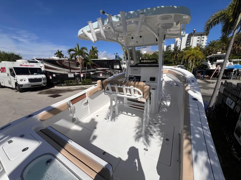 Slide: The Image of 2026 Sea Pro 262 Sport boat with T-top, docked in a sunny marina setting. - 4