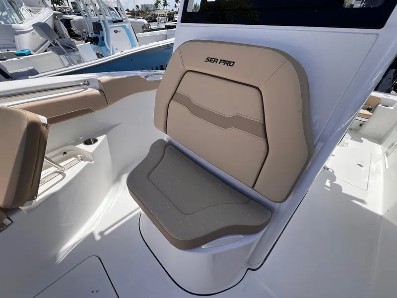Slide: The Image of 2026 Sea Pro 262 Sport boat seat with beige upholstery and sleek design. - 43