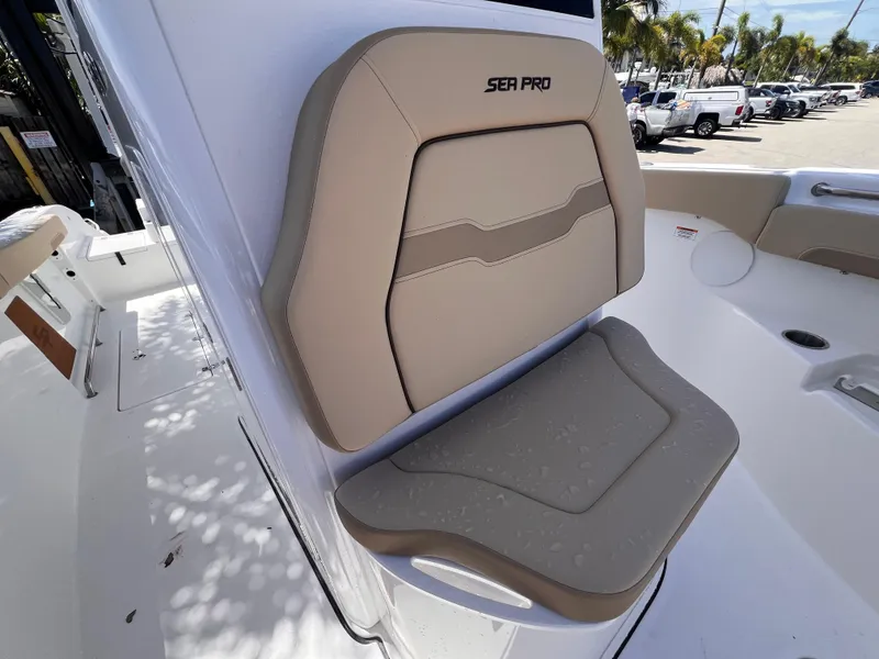 Slide: The Image of 2026 Sea Pro 262 Sport boat seat with beige upholstery and logo. - 44