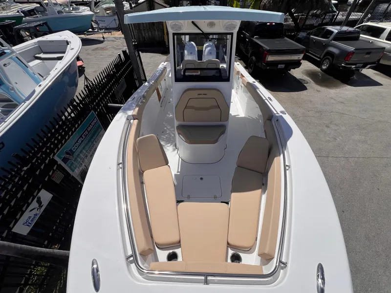 Slide: The Image of 2026 Sea Pro 262 Sport boat with beige seating, docked in a marina. - 45