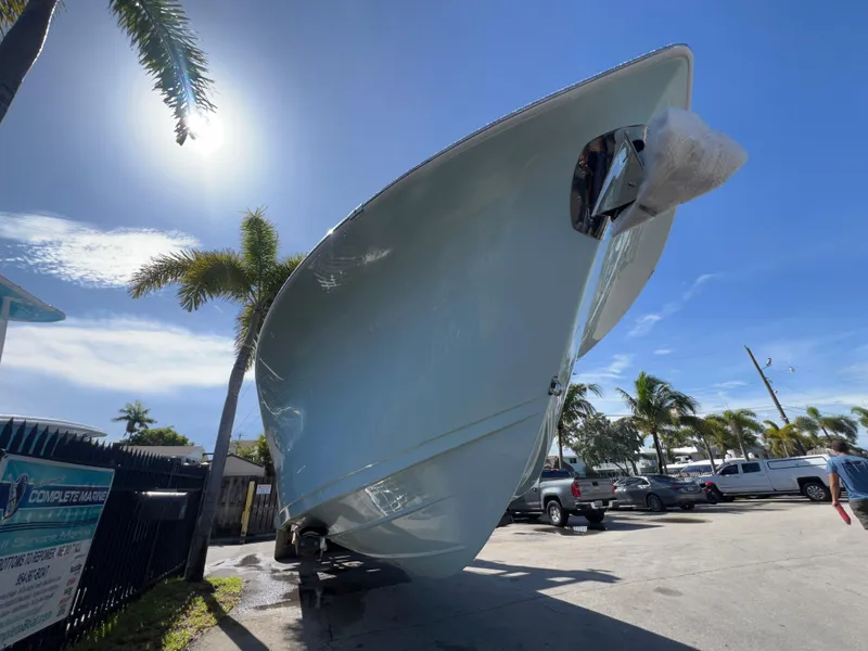 Slide: The Image of 2026 Sea Pro 262 Sport boat under bright blue sky with palm trees. - 46
