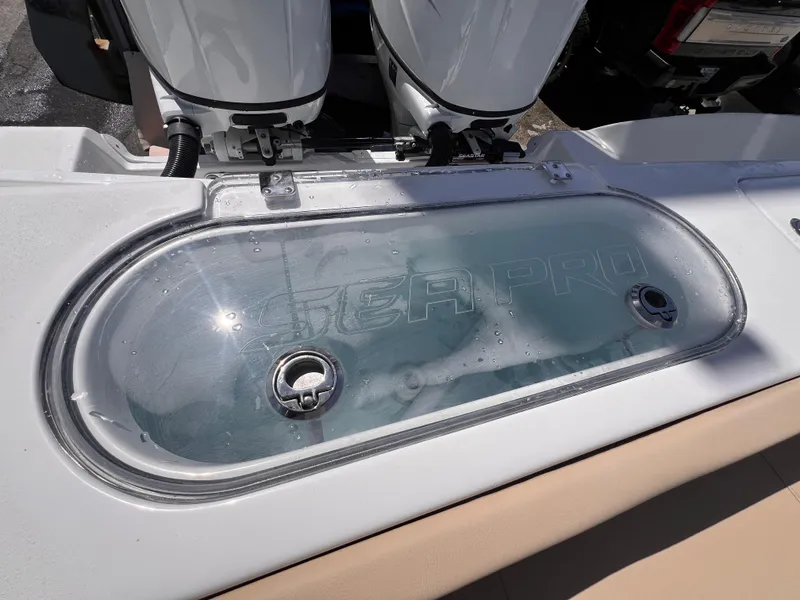 Slide: The Image of Livewell on 2026 Sea Pro 262 Sport boat, featuring dual outboard motors. - 49