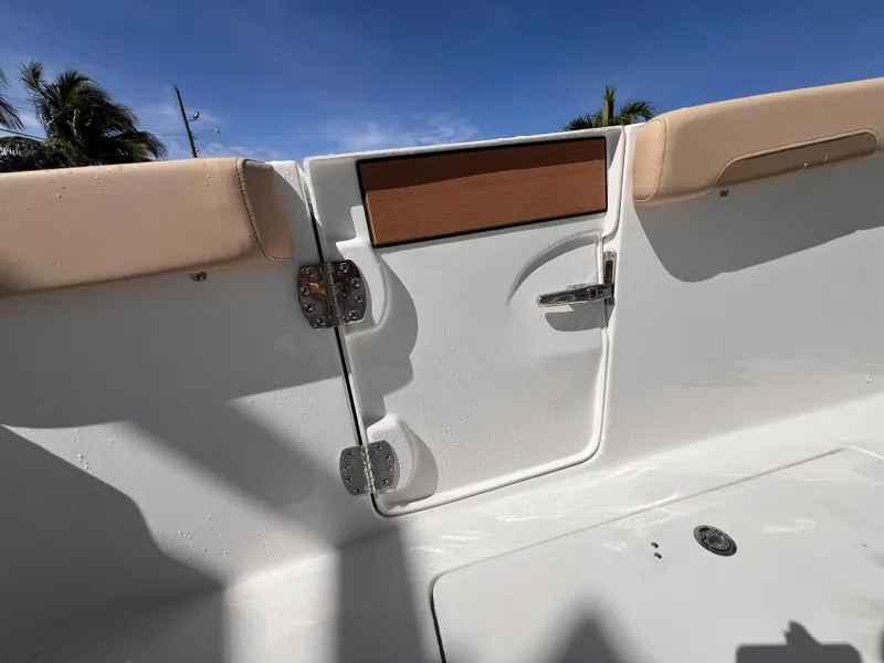 Slide: The Image of 2026 Sea Pro 262 Sport boat interior with beige seating and white paneling under blue sky. - 9
