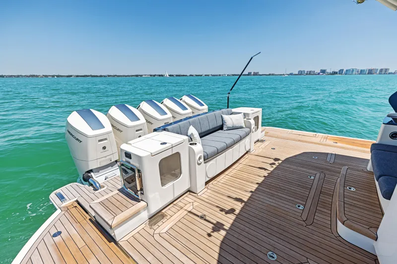 Slide: The Image of Luxurious 2026 Scout 670 LXS boat with spacious deck and multiple outboard engines. - 10