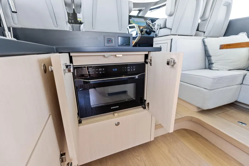 Slide: The Image of 2026 Scout 670 LXS interior with built-in Samsung microwave and modern seating area. - 18