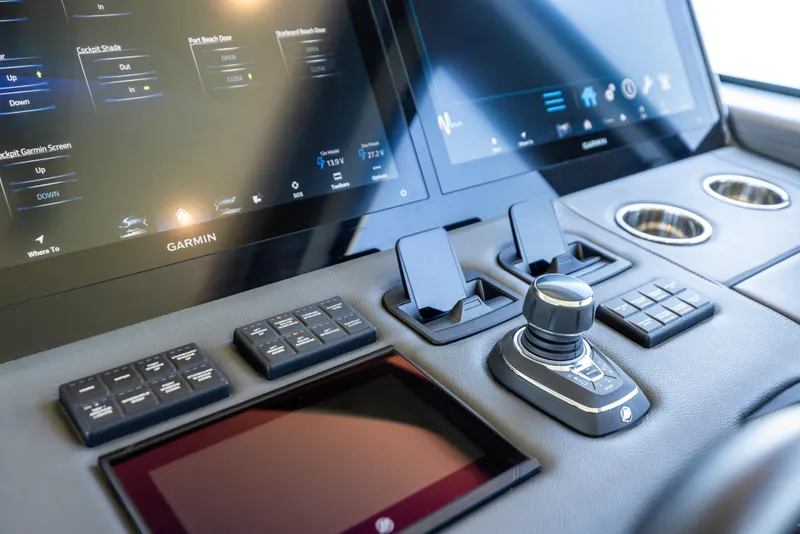 Slide: The Image of 2026 Scout 670 LXS boat dashboard with Garmin screens and control panel. - 21