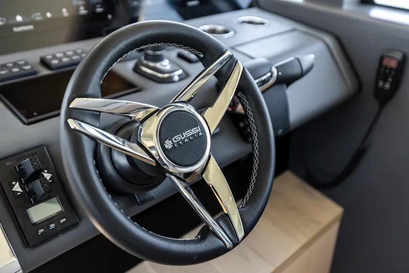 Slide: The Image of Steering wheel of 2026 Scout 670 LXS boat, featuring Gussi Italia design. - 22