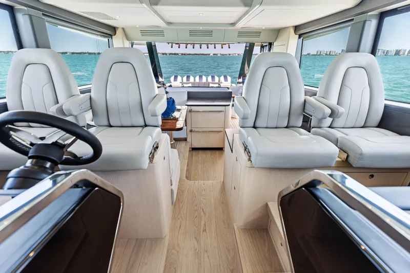 Slide: The Image of Luxurious interior of 2026 Scout 670 LXS yacht with plush seating and ocean view. - 24