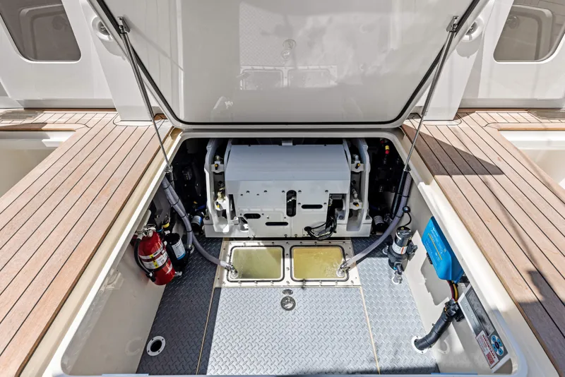 Slide: The Image of Engine compartment of 2026 Scout 670 LXS boat with open hatch and visible equipment. - 46
