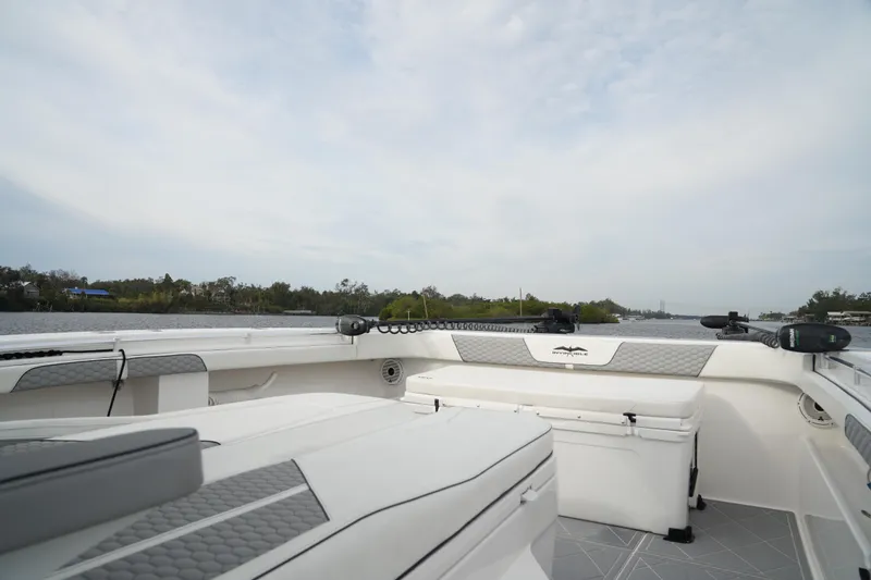 Slide: The Image of 2022 Invincible 46 Catamaran interior with seating and storage, cruising on a calm waterway. - 21