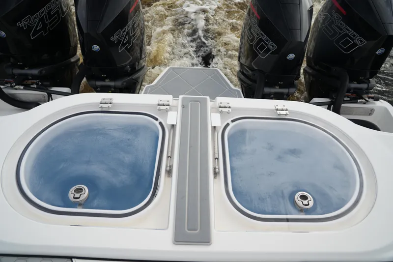 Slide: The Image of 2022 Invincible 46 Catamaran with dual livewells and powerful outboard engines. - 26