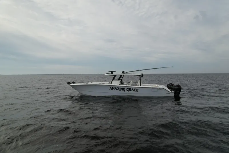 Slide: The Image of 2022 Invincible 46 Catamaran "Amazing Grace" on open water under cloudy sky. - 3