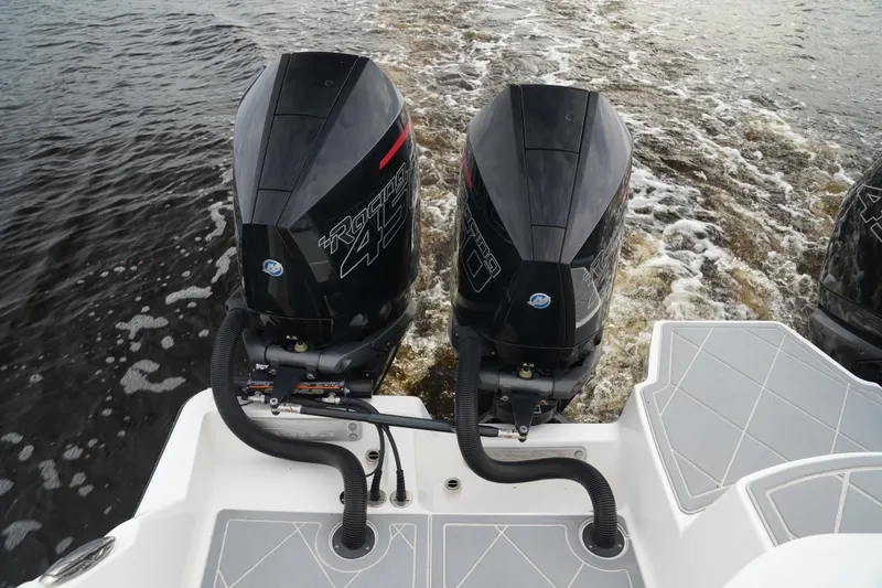 Slide: The Image of Twin outboard engines on 2022 Invincible 46 Catamaran, cruising on water. - 31