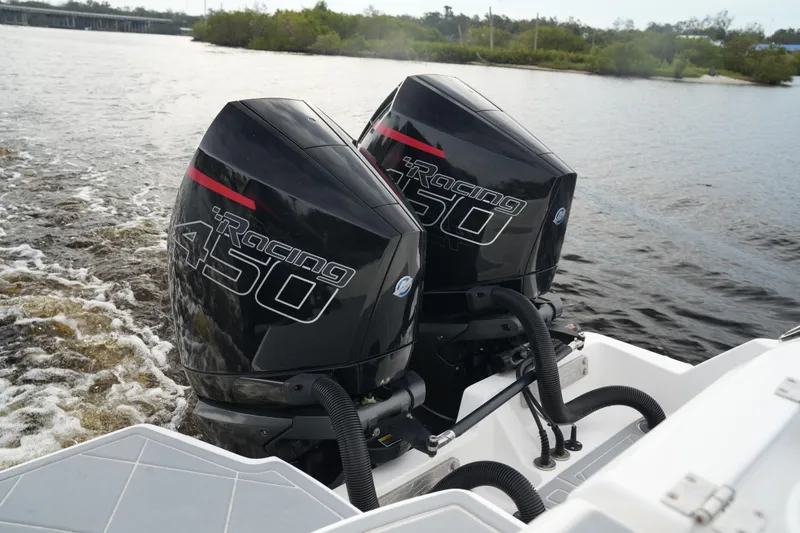 Slide: The Image of Twin Racing 450 engines on 2022 Invincible 46 Catamaran, cruising on a river. - 33