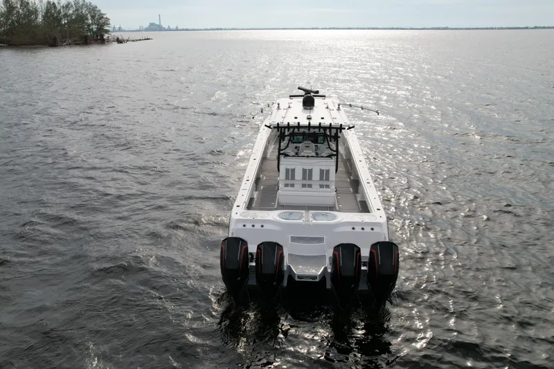 Slide: The Image of Invincible 46 Catamaran 2022 cruising on open water, rear view. - 5