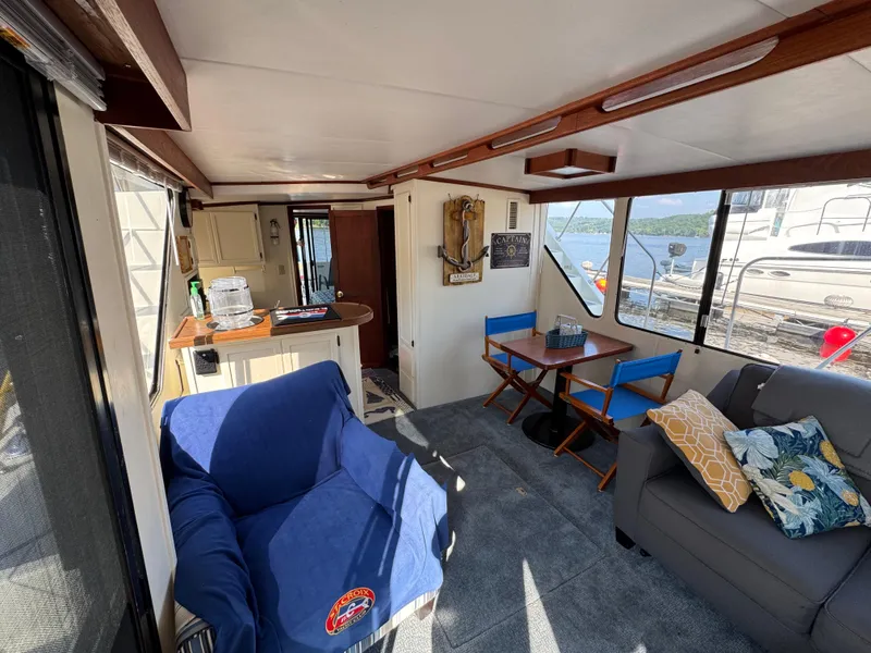 Slide: The Image of Interior of 1985 Bluewater Yachts 51 Coastal Cockpit MY with cozy seating and lake view. - 15