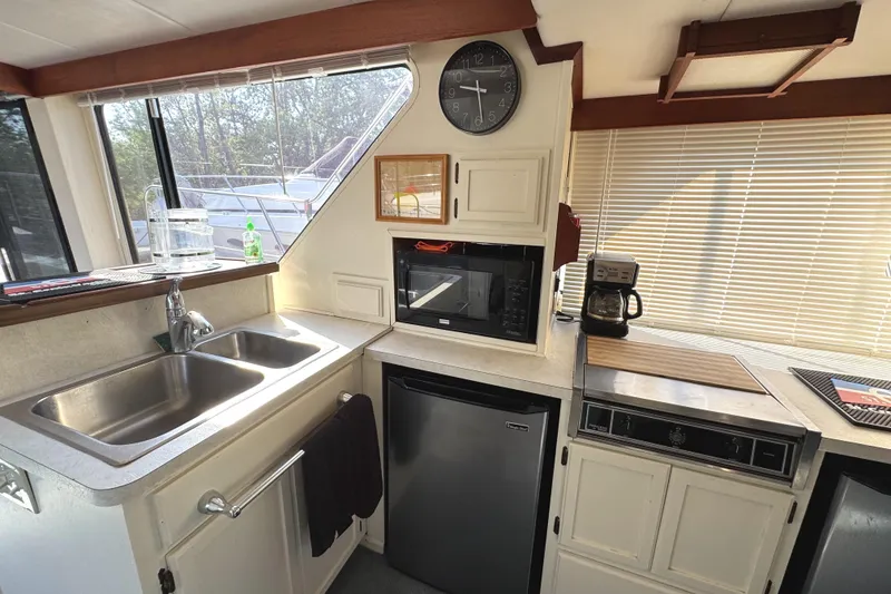 Slide: The Image of 1985 Bluewater Yachts 51 Coastal Cockpit MY kitchen with sink, microwave, and coffee maker. - 17